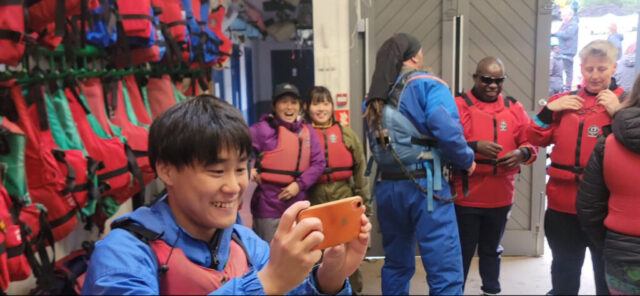 One of the young people takes a selfie as everyone prepares to go canoeing